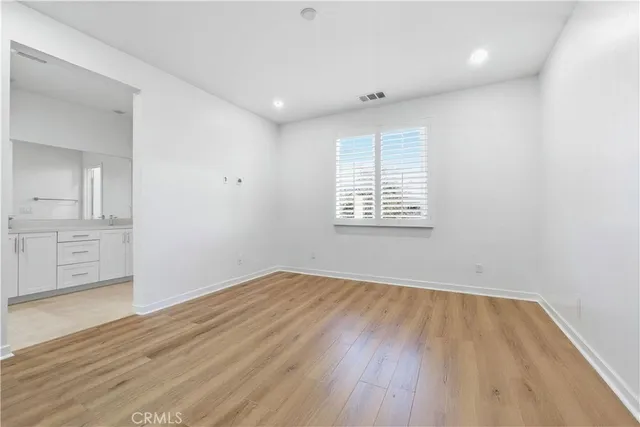 a bathroom with double sink and a mirror
