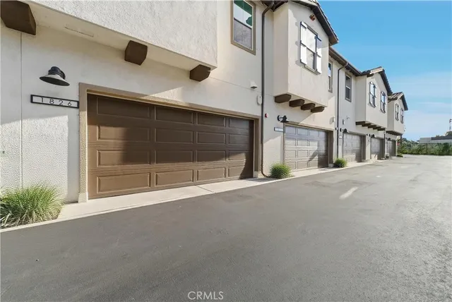 a view of a backyard with table and chairs under an umbrella