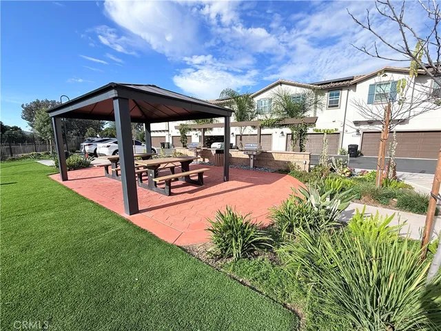 a backyard of a house with table and chairs