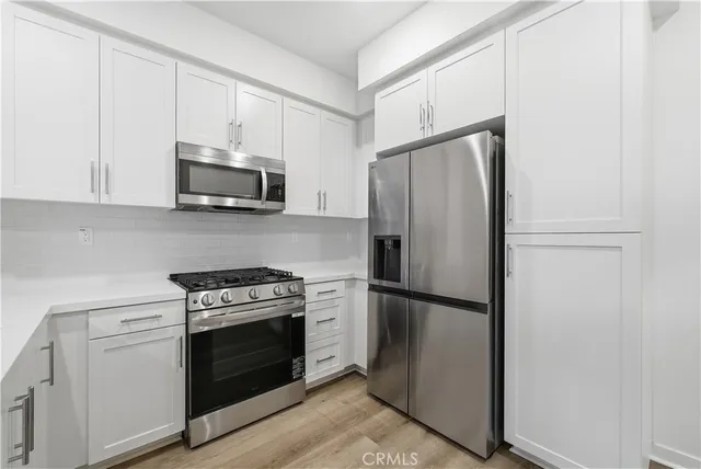 a kitchen with a refrigerator stove and microwave