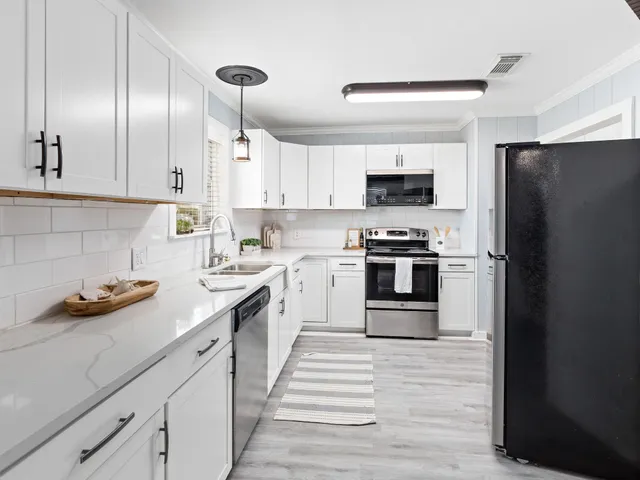 a kitchen with cabinets stainless steel appliances and a sink