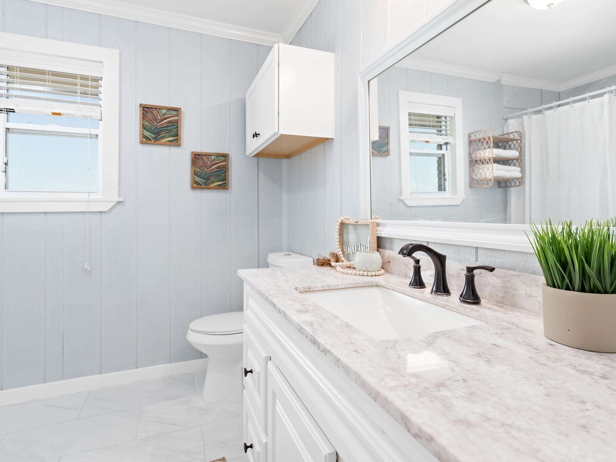 2055 State Highway 87 Crystal Beach, TX 77650 - Photo 16 of 32 a bathroom with a sink a toilet and a mirror