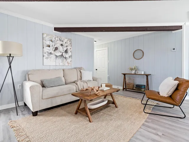 a living room with furniture and a chair