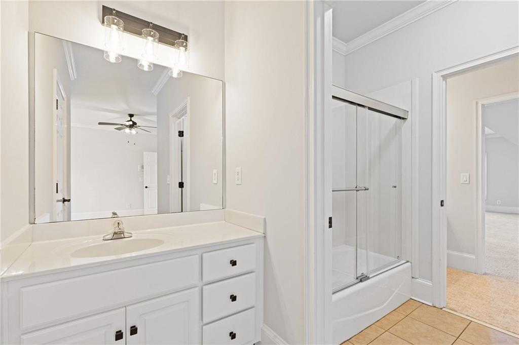 2010 Legends Way Braselton, GA 30517 - Photo 44 of 77 a bathroom with a shower sink and mirror