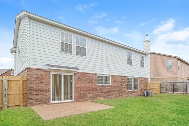 a view of a house with a backyard