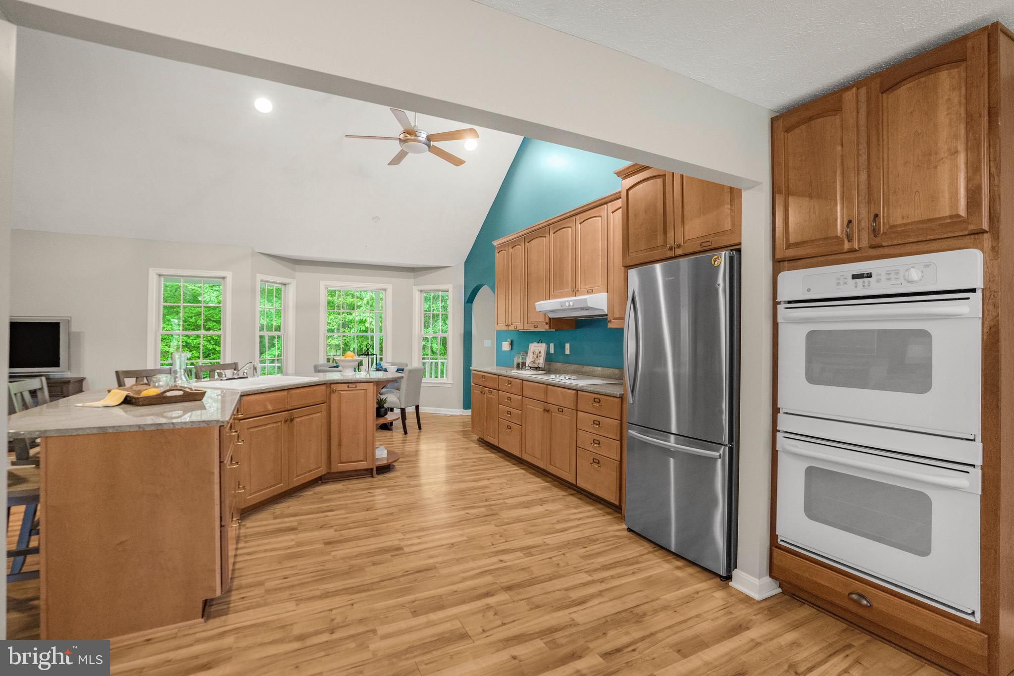 21549 Point Lookout Road Callaway, MD 20620 - Photo 12 of 41 a kitchen with refrigerator cabinets and wooden floor