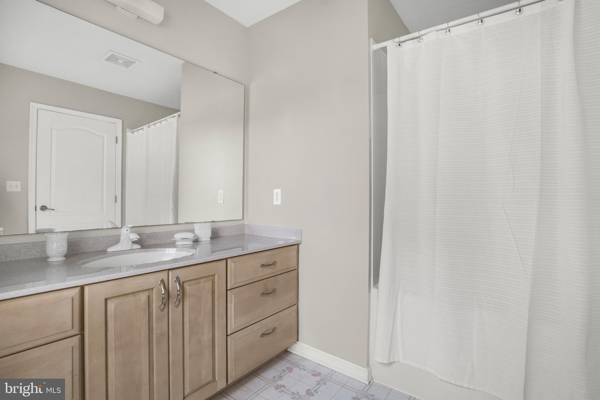 21549 Point Lookout Road Callaway, MD 20620 - Photo 20 of 41 a bathroom with a granite countertop sink and a mirror