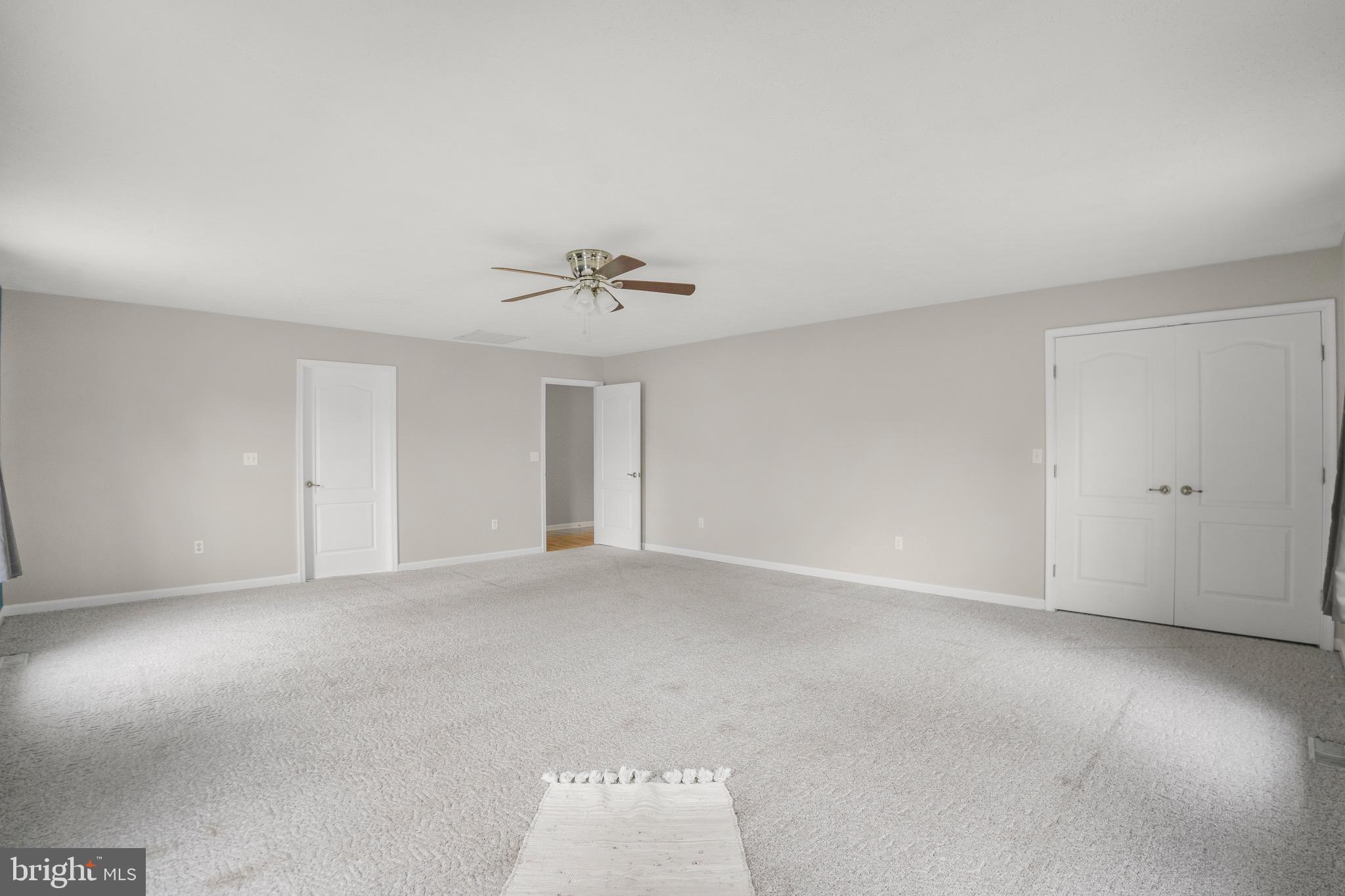 21549 Point Lookout Road Callaway, MD 20620 - Photo 23 of 41 a view of an empty room with a chandelier fan