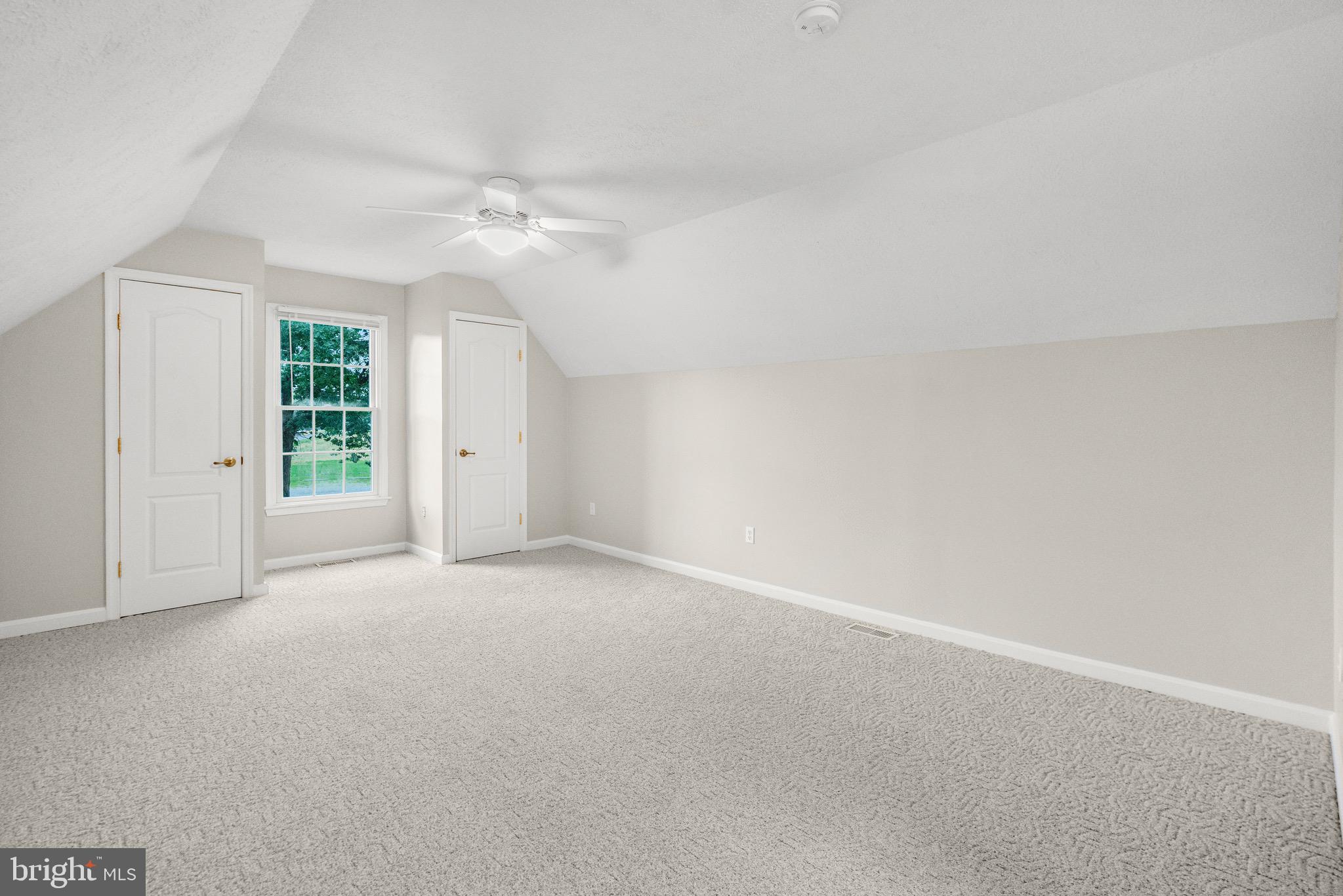 21549 Point Lookout Road Callaway, MD 20620 - Photo 28 of 41 an empty room with windows and ceiling fan