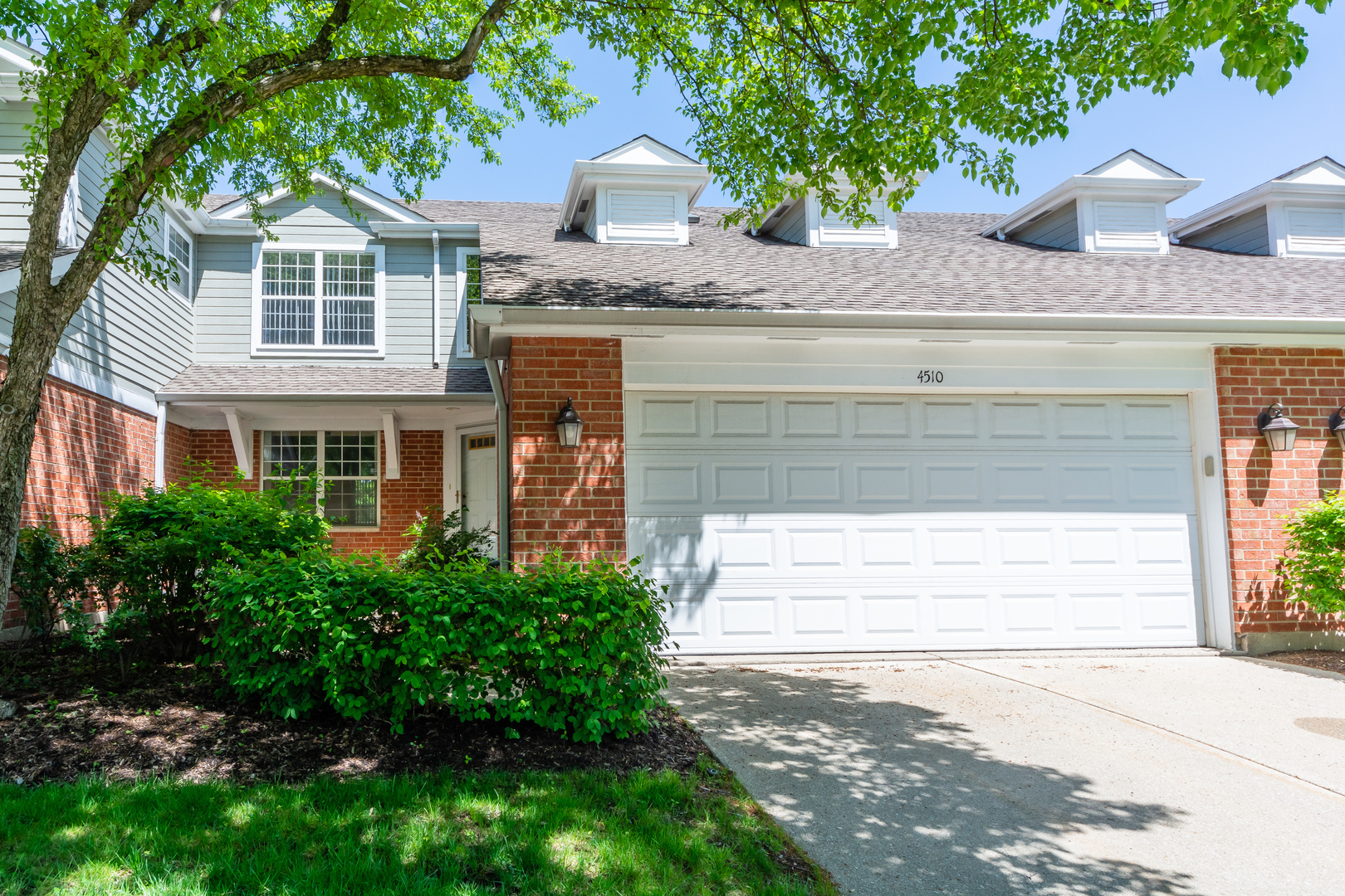 a front view of a house with a yard and garage