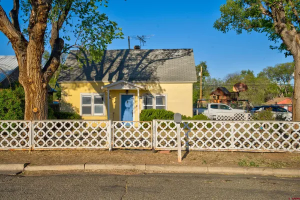 front view of a house with a bench