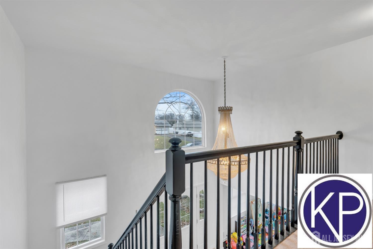 109 Jordan Road Colonia, NJ 07067 - Photo 17 of 30 a view of a hallway with washer and chandelier
