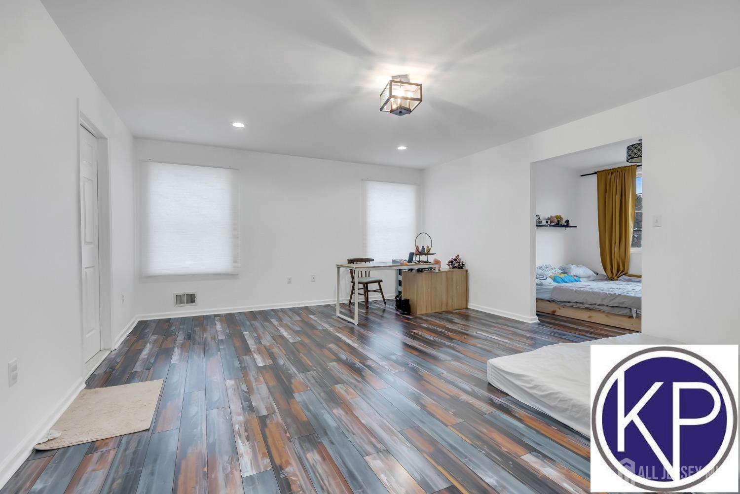 109 Jordan Road Colonia, NJ 07067 - Photo 18 of 30 a view of kitchen and dining room with wooden floor