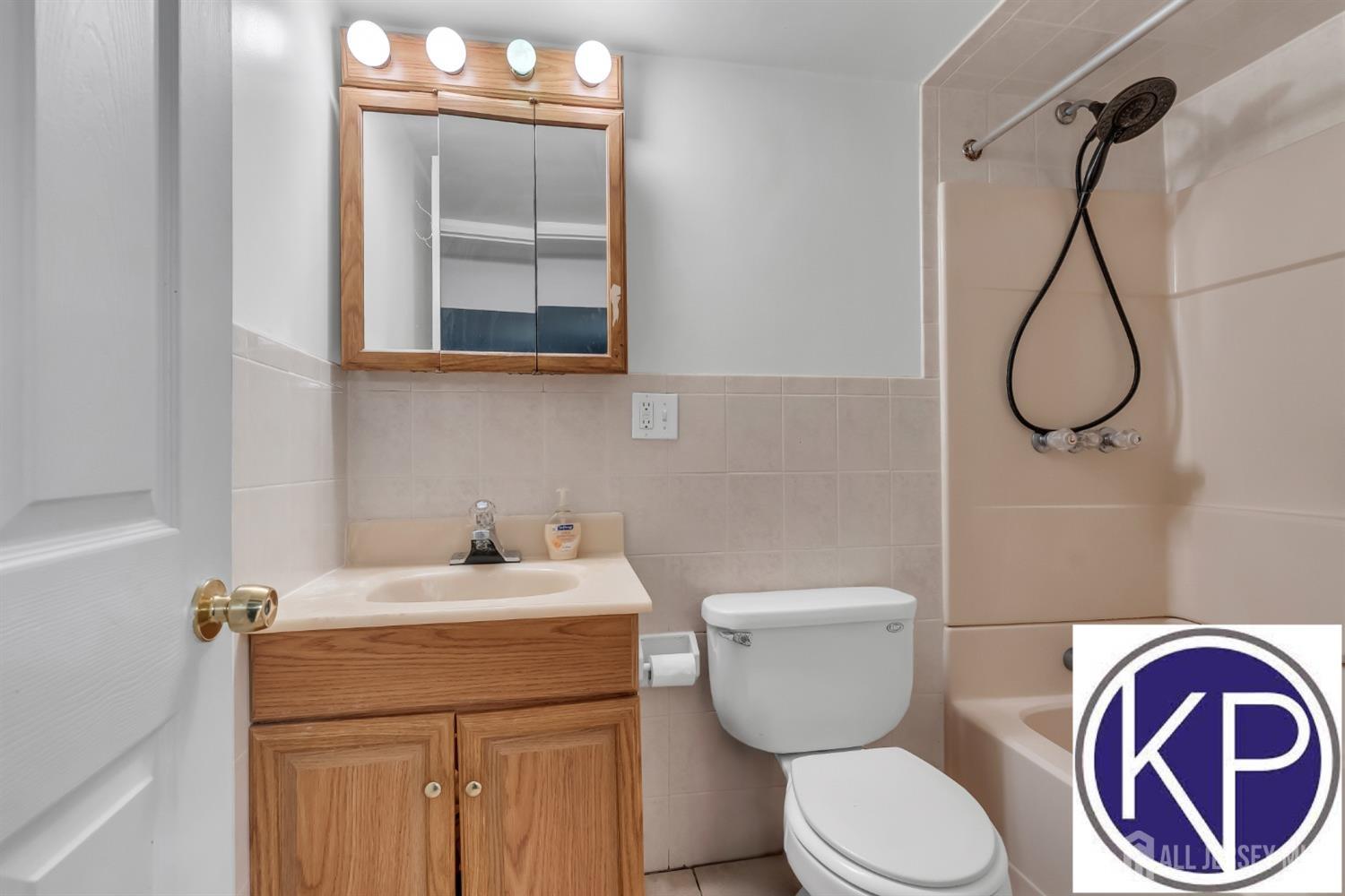 109 Jordan Road Colonia, NJ 07067 - Photo 25 of 30 a bathroom with a toilet sink and mirror