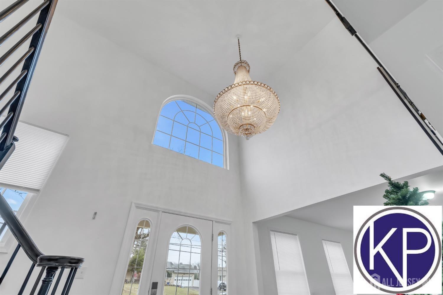 109 Jordan Road Colonia, NJ 07067 - Photo 3 of 30 a view of wooden floor and a chandelier in a room