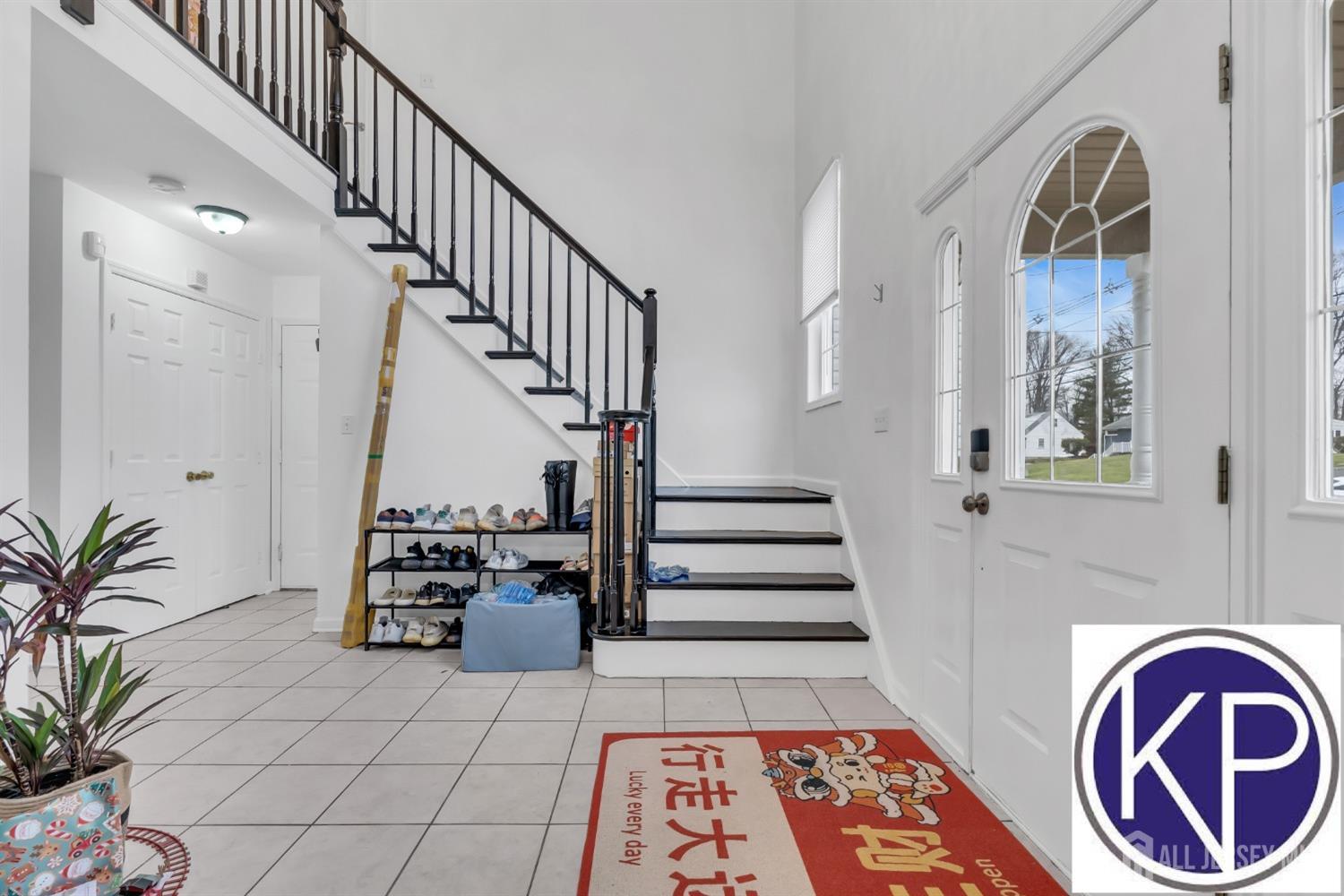 109 Jordan Road Colonia, NJ 07067 - Photo 5 of 30 a view of entryway with wooden floor and a chandelier