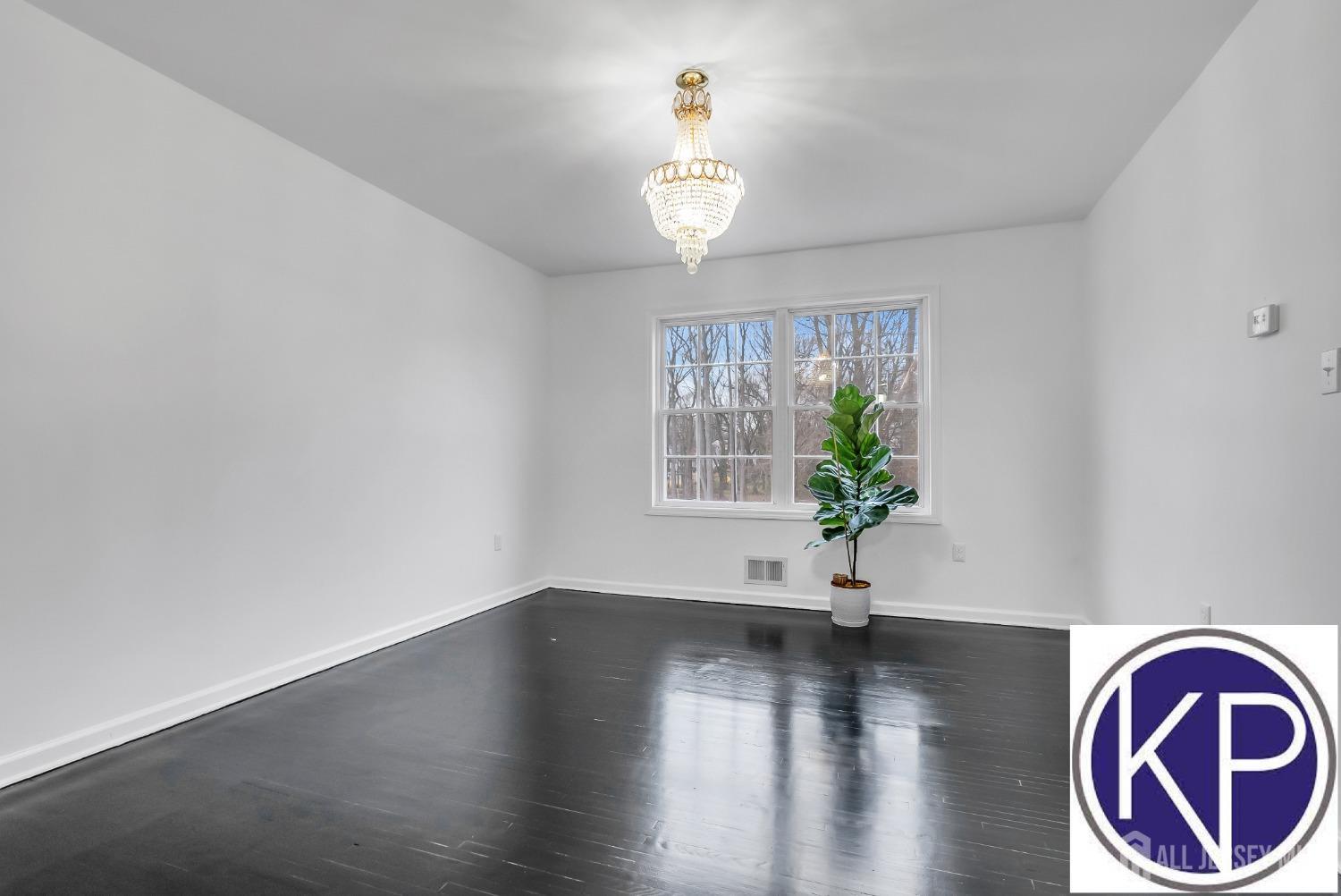109 Jordan Road Colonia, NJ 07067 - Photo 8 of 30 a view of an empty room with wooden floor and a window
