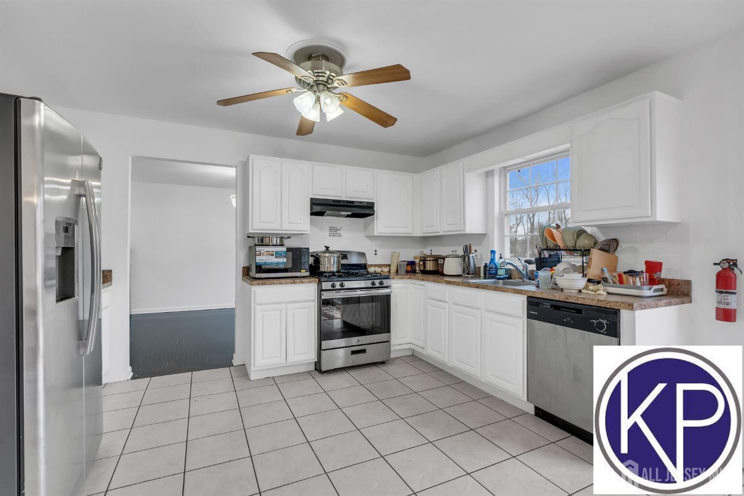 109 Jordan Road Colonia, NJ 07067 - Photo 10 of 30 a kitchen with granite countertop a refrigerator a stove top oven a sink and dishwasher