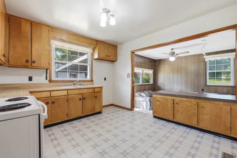 a kitchen with sink cabinets and window