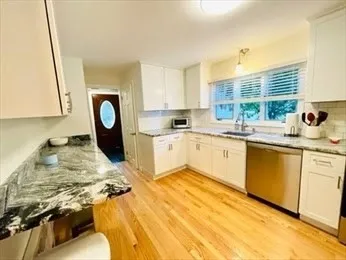 a kitchen with a stove a sink and a cabinets