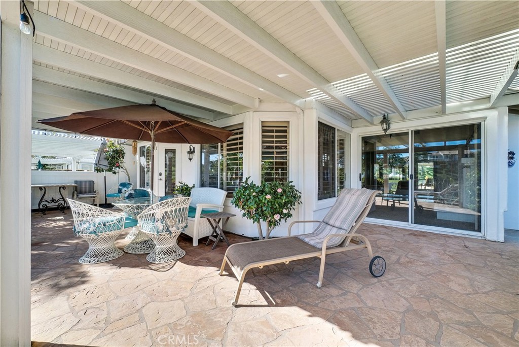 4729 Majorca Way Oceanside, CA 92056 - Photo 18 of 32 a view of a patio with a table and chairs under an umbrella