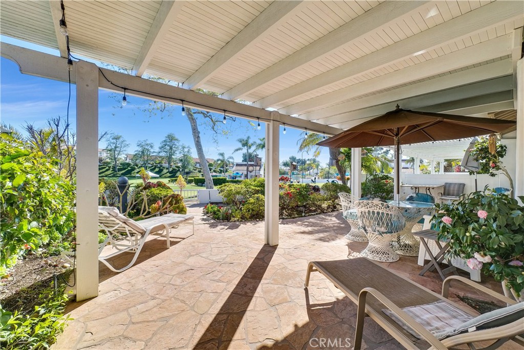 4729 Majorca Way Oceanside, CA 92056 - Photo 20 of 32 a view of a patio with table and chairs potted plants with wooden floor