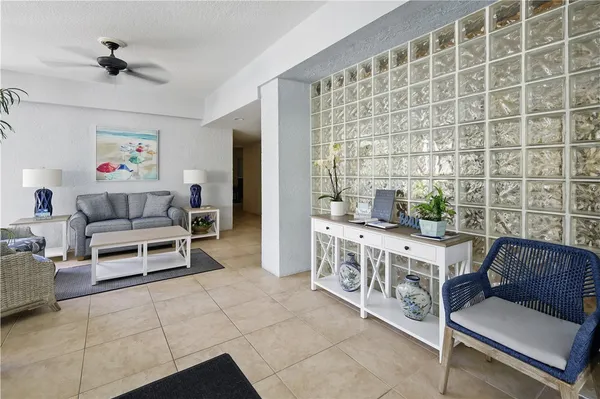 a living room with furniture flower pot and a potted plant