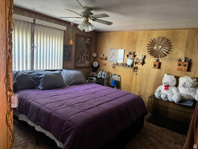 123 North 3rd Manila, UT 84046 - Photo 12 of 15 Bedroom featuring wood paneling, a ceiling fan with integrated lighting, and vertical blinds on the window