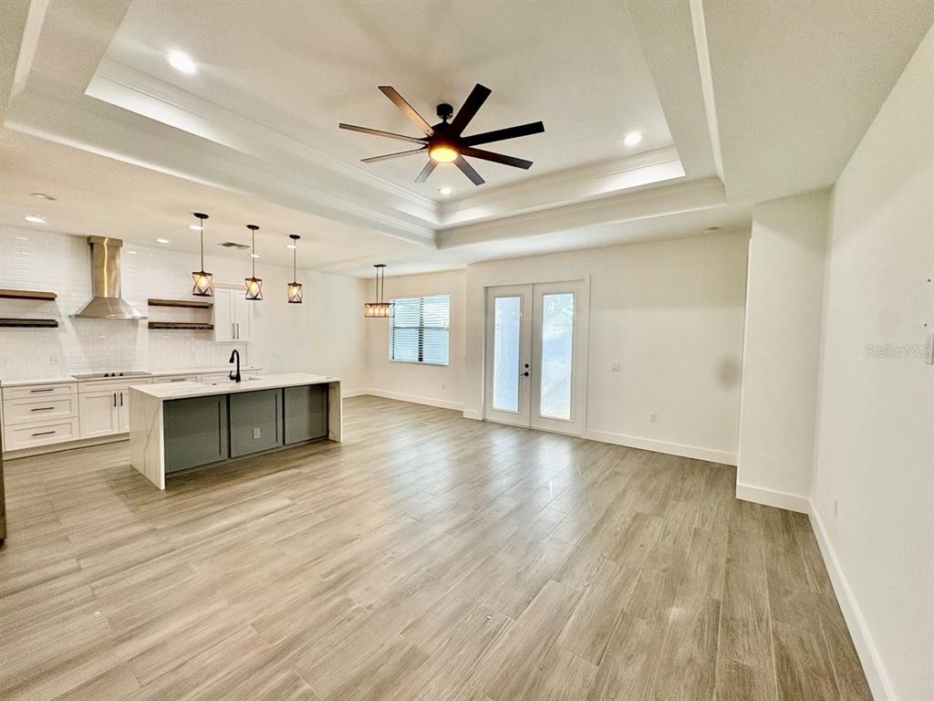 3228 West Beach Street Tampa, FL 33607 - Photo 7 of 22 a view of an empty room with window and wooden floor