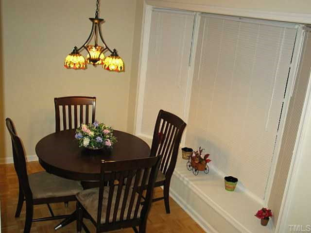 Formal dining room features bay window parque wood flooring and updated lighting. Dining Room