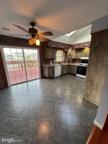 a view of a livingroom with a ceiling fan and window