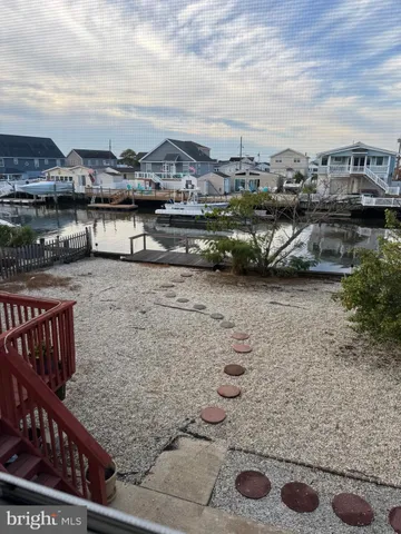 a view of a kitchen with kitchen island and wooden floor