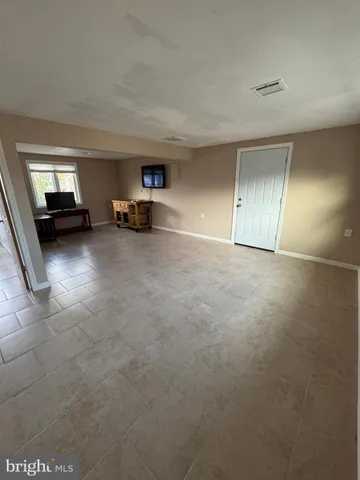 a view of empty room with a fireplace