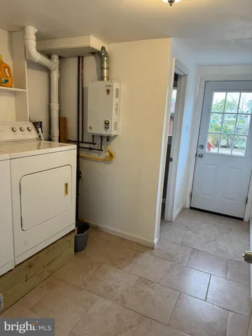 a view of a storage & utility room with closet window