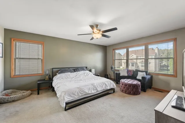 a spacious bedroom with a bed and a window