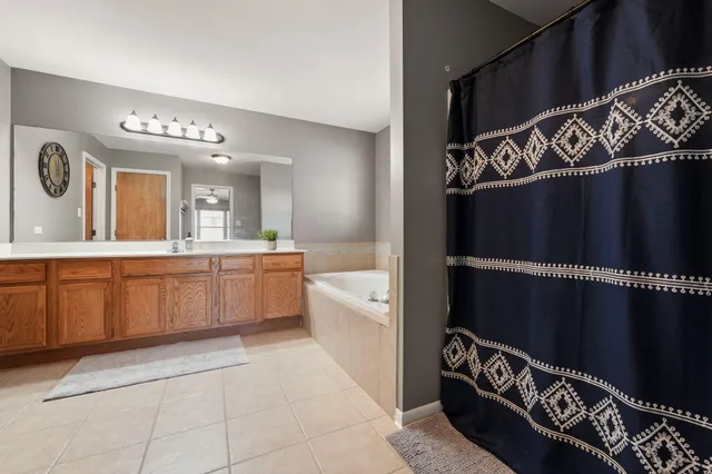 a bathroom with a sink a mirror and a bathtub