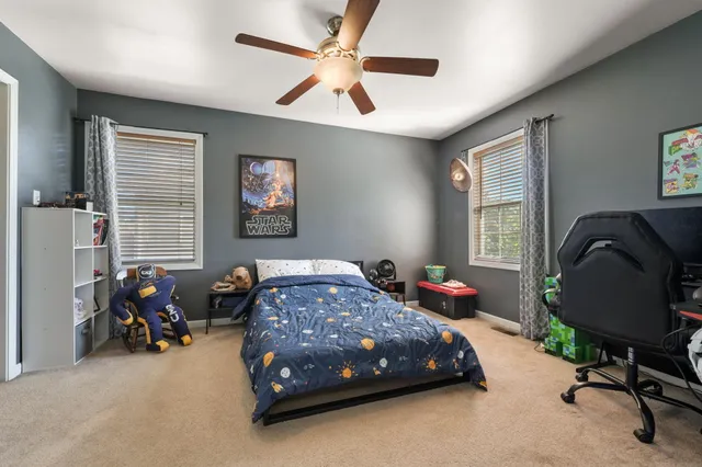 a bedroom with bed and a window