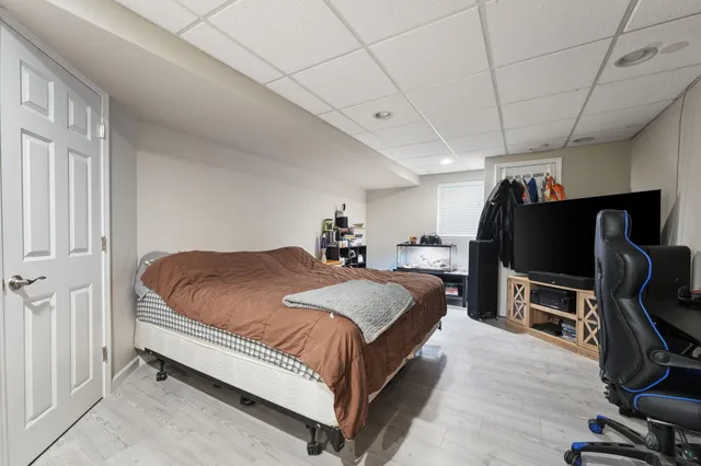 a bed room with a bed tv and a chair