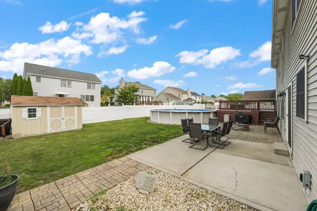 a view of a house with backyard porch and sitting area