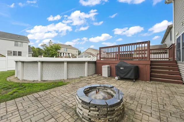 a backyard of a house with table and chairs