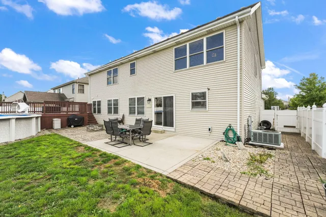 a view of a house with backyard and sitting area