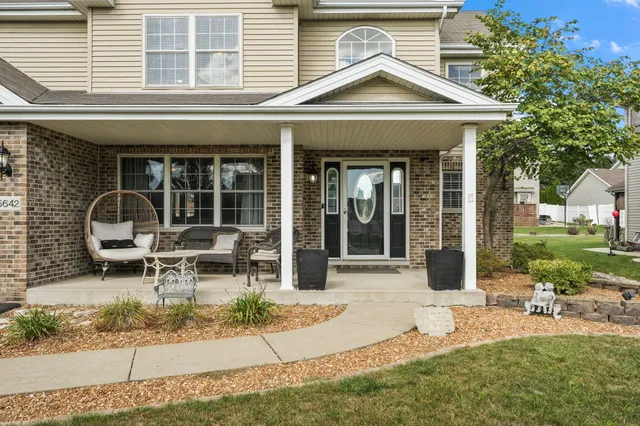 a view of a house with backyard porch and sitting area