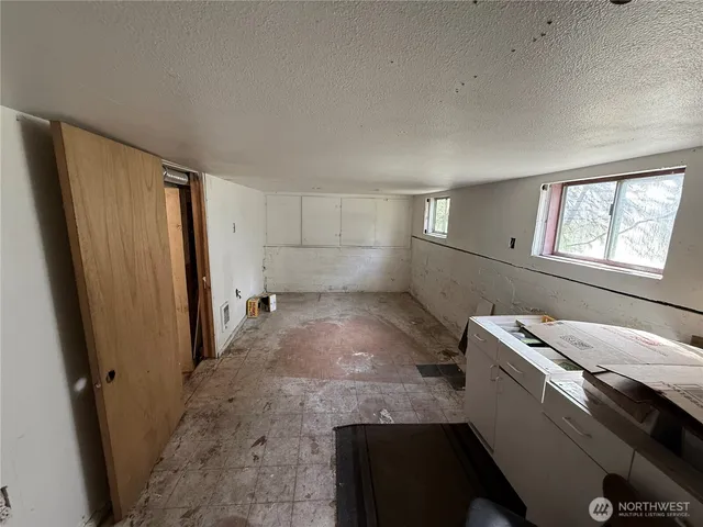 a view of storage and utility room with a window