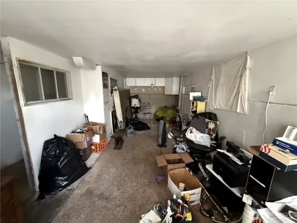 a living room with furniture a window and gym equipment