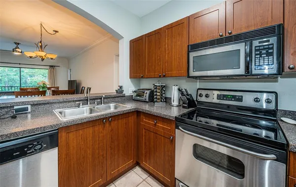 a kitchen with a sink stove and microwave