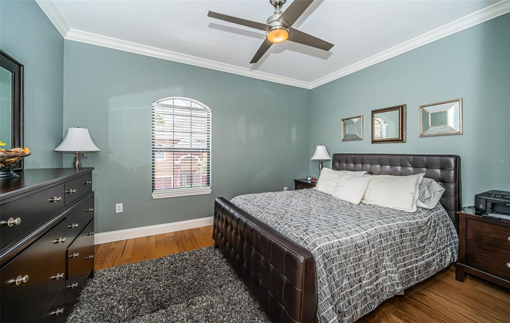 2138 Chianti Place, Unit 142 Palm Harbor, FL 34683 - Photo 16 of 40 a bedroom with a bed and wooden floor