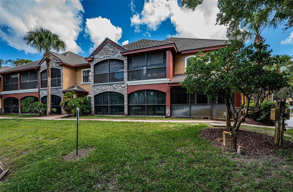 2138 Chianti Place, Unit 142 Palm Harbor, FL 34683 - Photo 20 of 40 a front view of a house with a yard