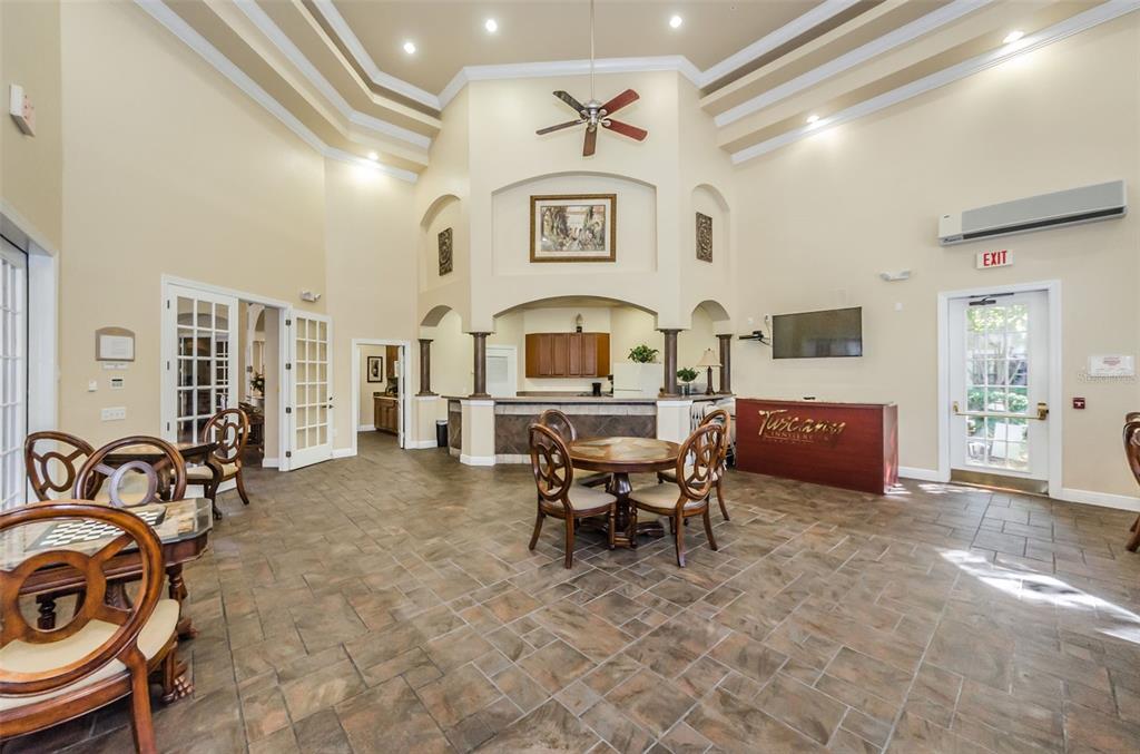 2138 Chianti Place, Unit 142 Palm Harbor, FL 34683 - Photo 24 of 40 a living room with furniture a chandelier and a stove