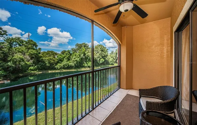 a view of a balcony with chair and wooden floor