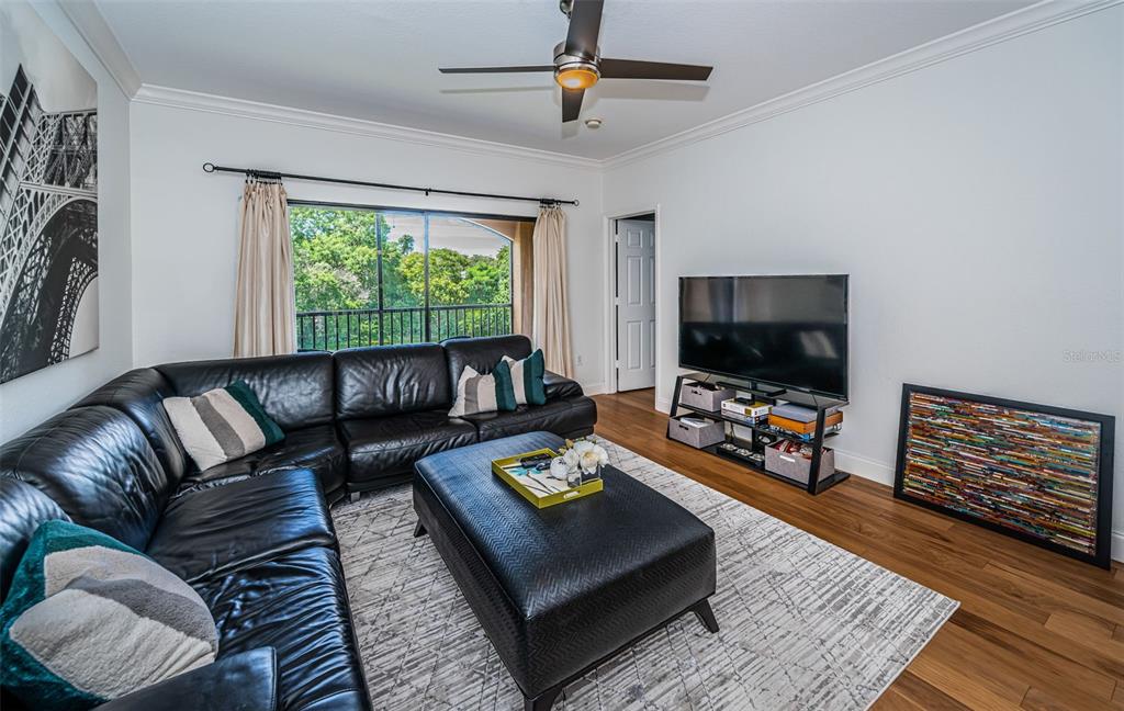 2138 Chianti Place, Unit 142 Palm Harbor, FL 34683 - Photo 6 of 40 a living room with furniture and a flat screen tv